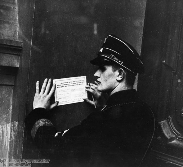 An SS Member Signs the Oath of Loyalty to Hitler at a Mass Rally on the People’s Day of Mourning (February 25, 1934)